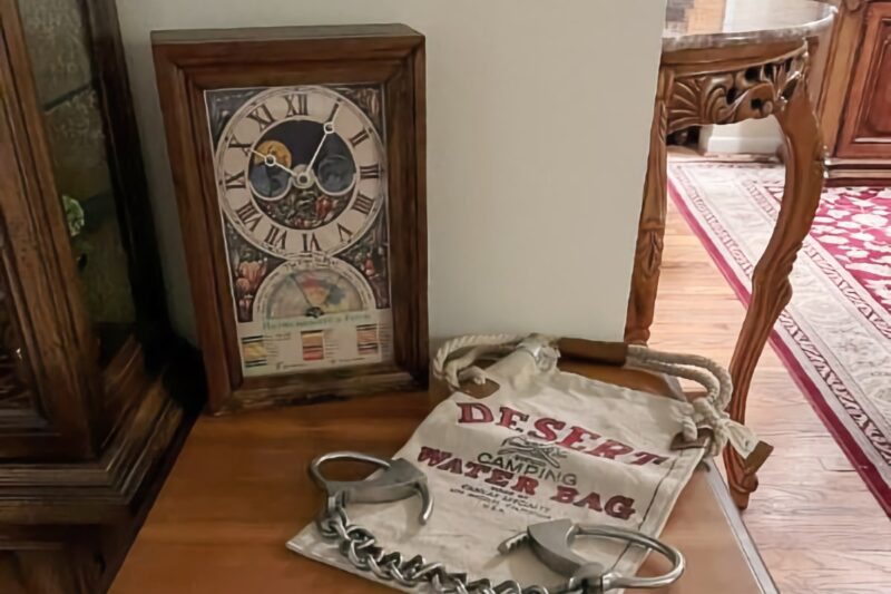 vintage desert water bag and vintage abercrombie & fitch clock on display at an estate sale in Birmingham, Michigan