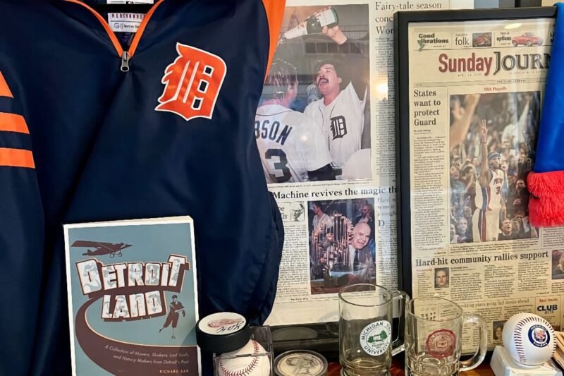 A plethora of Detroit sports memorabilia including a Detroit Tigers jackets and framed newspaper pages