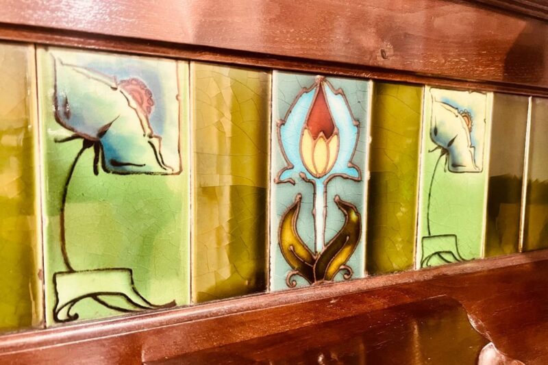 floral tile inlay in wooden credenza